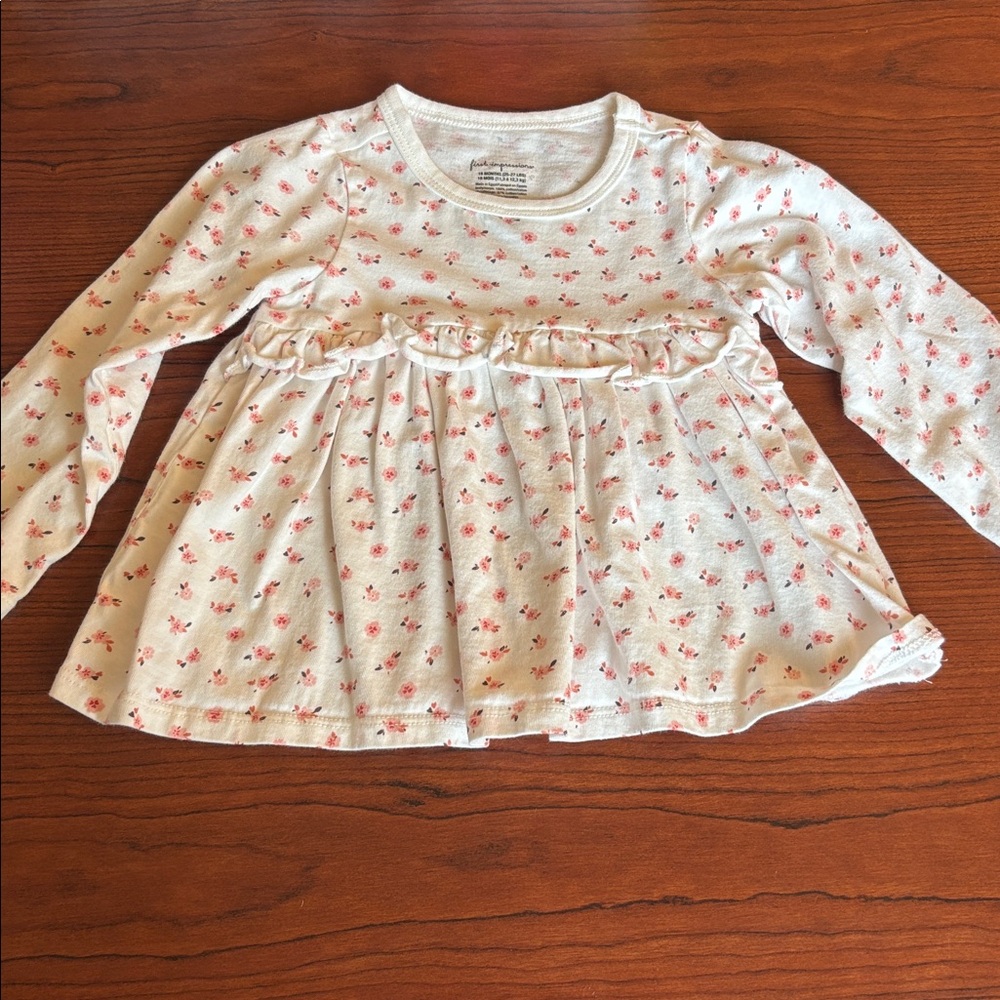 First Impressions long-sleeve babydoll top with ruffles.